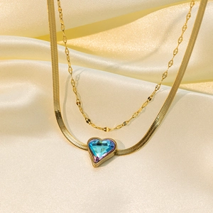 Detail of 18K gold double layer necklace with iridescent heart crystal pendant