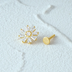 Macro detail of S925 sterling silver gold flower earrings with clear zircon stones