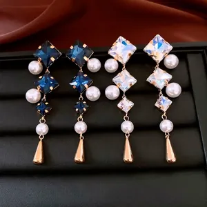 Vintage geometric earrings with pearls and crystals on premium black leather stand