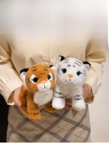 Detail of plush tiger toys in white and yellow with soft fur and realistic blue eyes