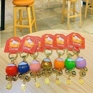 Colorful Maneki Neko Daruma bell keychains with metal paint finish in seven vibrant colors