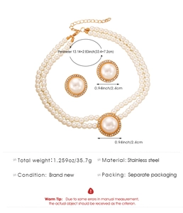 Detail view of double-layer pearl necklace with rhinestone-set V-pendant and matching earrings