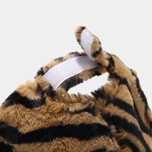 Detailed macro view of plush tiger print faux fur texture and white velcro strap closure