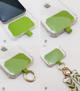 Detailed view of green phone lanyard patch installation with decorative floral strap