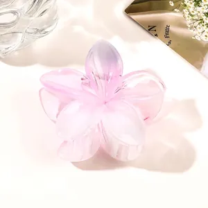 Macro view of a gradient pink flower hair claw clip with transparent resin finish