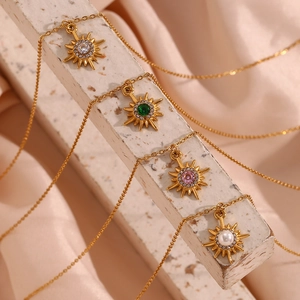 Detail of 18K gold plated sunburst necklaces with colorful zircon and pearl pendants