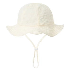 Detail of baby cotton gauze sun hat with adjustable drawstring and breathable muslin texture