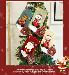 Close-up of Christmas stockings with Santa, snowman and reindeer hanging on a tree