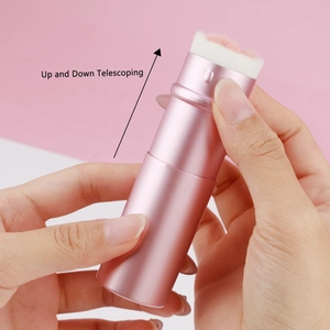 Detail of pink telescoping cat paw brush showing the smooth up and down movement mechanism