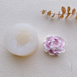 Macro view of a 3D jasmine flower silicone mold with a purple finished gypsum craft