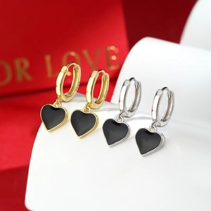 Macro shot of S925 sterling silver heart earrings with black enamel and hallmarked stamps