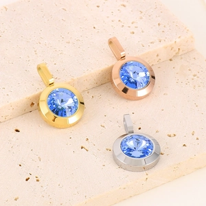 Three-color round pendants with blue faceted gemstones in gold, silver, and rose gold