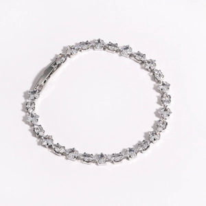 Close-up of silver tennis bracelet with square-cut cubic zirconia in a four-prong setting