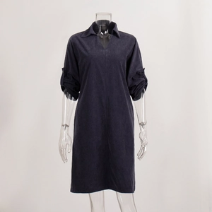 Detailed view of navy corduroy dress V-neckline and adjustable buttoned sleeves