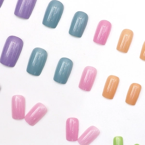 Short square press-on nails in pastel aurora colors with glossy finish and glitter