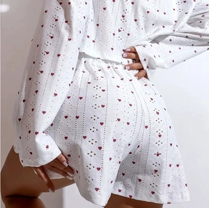Women's white long sleeve pajama set with red heart prints and eyelet embroidery detail