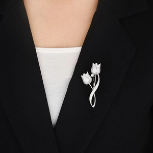 Elegant silver tulip brooch with shimmering micro-pave crystals on a black suit lapel