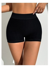 Close-up of black high-waisted yoga shorts featuring honeycomb textured fabric and bow detail