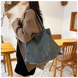 Close-up of minimalist large tote bag in matte dark grey with shoulder strap