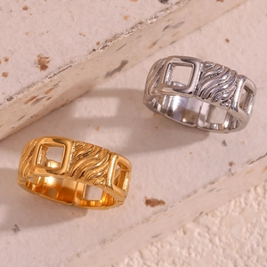 Detail of square cutout rings in gold and silver finish with textured twill pattern