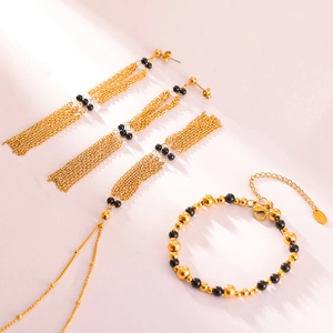 Vintage gold-plated titanium steel jewelry set featuring black agate beads and tassels