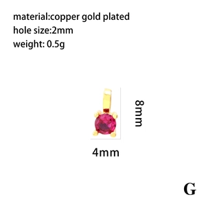 Macro detail of 8mm round red zircon pendant with 18K gold plated copper setting