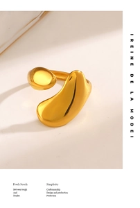 Detailed view of irregular golden liquid metal ring with smooth mirror polished finish