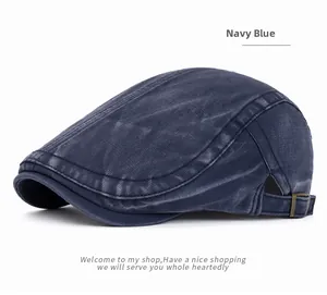 Detail view of navy blue washed cotton flat cap with vintage texture and metal buckle