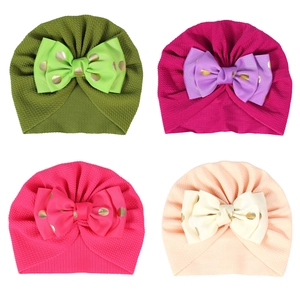 Newborn baby turban hats with large gold dot bows in multiple pastel colors