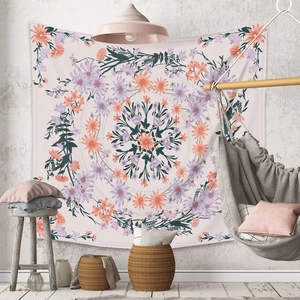 Detail of bohemian mandala tapestry featuring pink floral patterns in a cozy room setting
