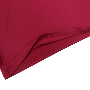 Close-up of double-needle stitching and smooth fabric on the hem of a burgundy dress