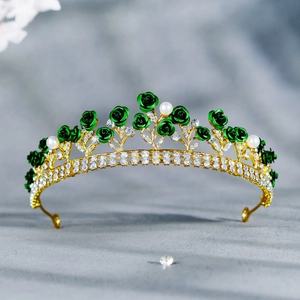 Detail of golden bridal crown with emerald green resin roses and crystal embellishments