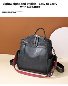 Detail of black faux leather backpack with vintage texture and colorful striped strap