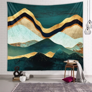 Detailed view of abstract mountain tapestry with metallic gold accents on textured wall