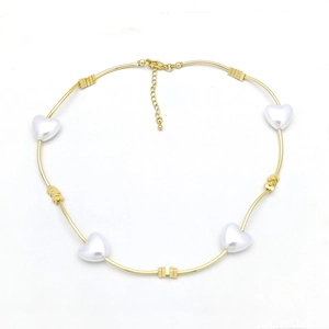 Golden collar necklace with white heart pearls and square metal charms on white background