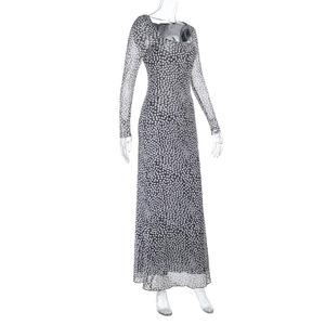Detail view of long sleeve grey polka dot dress featuring slim fit sheer mesh fabric