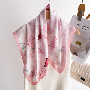 Elegant pink gradient silk scarf with lotus and butterfly prints on wooden hanger