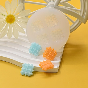 Macro view of a white silicone mold for creating miniature square waffle dessert pieces