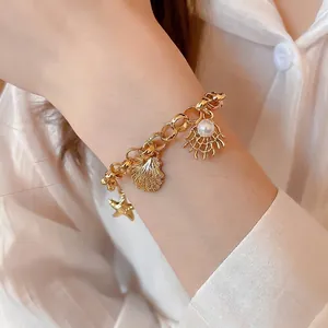 Gold stainless steel charm bracelet with starfish, seashell and pearl charms for ocean style