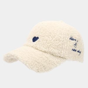 Detail of plush cream fleece baseball cap with heart and 'Have a nice day' embroidery