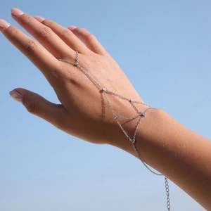Elegant silver finger bracelet with zircon tassels and geometric chain on hand
