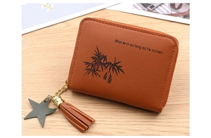 Detailed macro view of a brown mini coin purse with bamboo print and tassel star charm