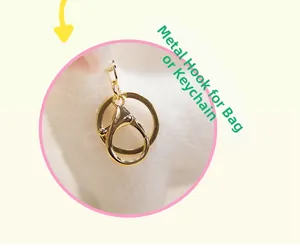 Detail view of the high-quality gold metal lobster clasp and ring on white plush toy charm