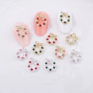 Christmas wreath nail charms with bows, pearls, and rhinestones on artificial tips