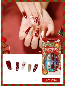 Christmas press on nails set with red and gold snowflake patterns and bows in box