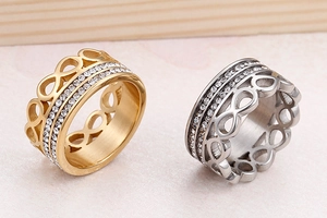 Detail of silver and gold infinity rings with double row zirconia pave settings