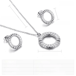 Detail of round stainless steel jewelry set with radial texture on necklace and earrings