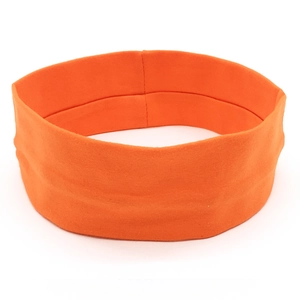 Detail shot of bright orange elastic yoga headband with smooth knitted fabric and stitching