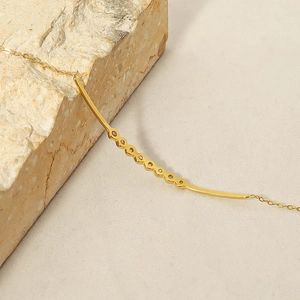 Elegant 18k gold plated bracelet with sparkling zircons on minimalist curved bar