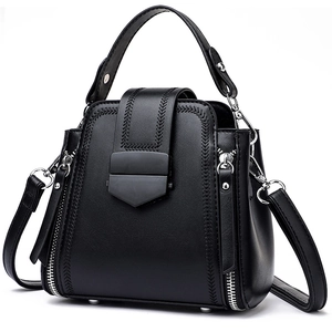 Modern black leather tote bag for women featuring woven stitch detail and top handle
